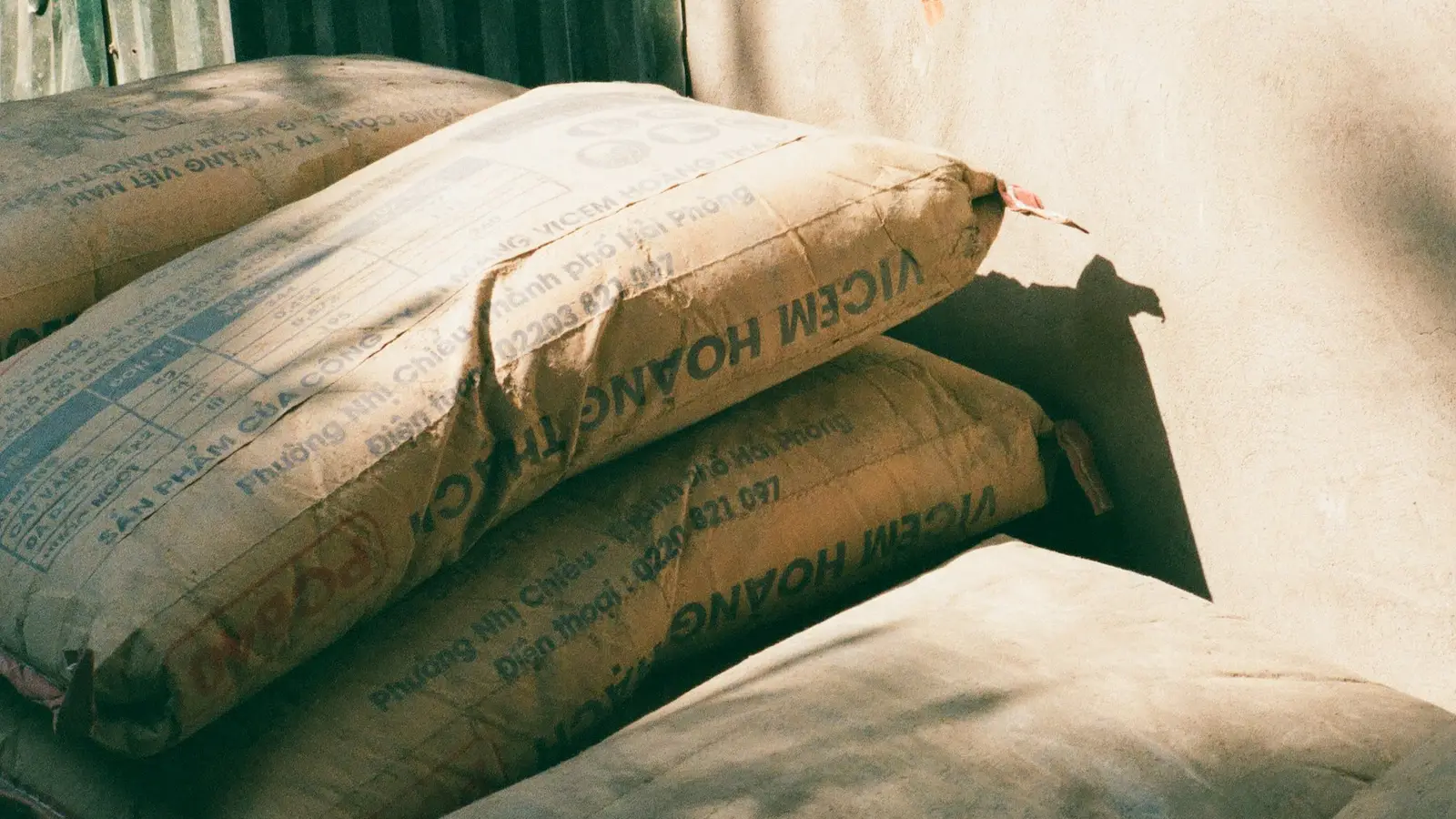 Stacks of cement bags in sunlight
