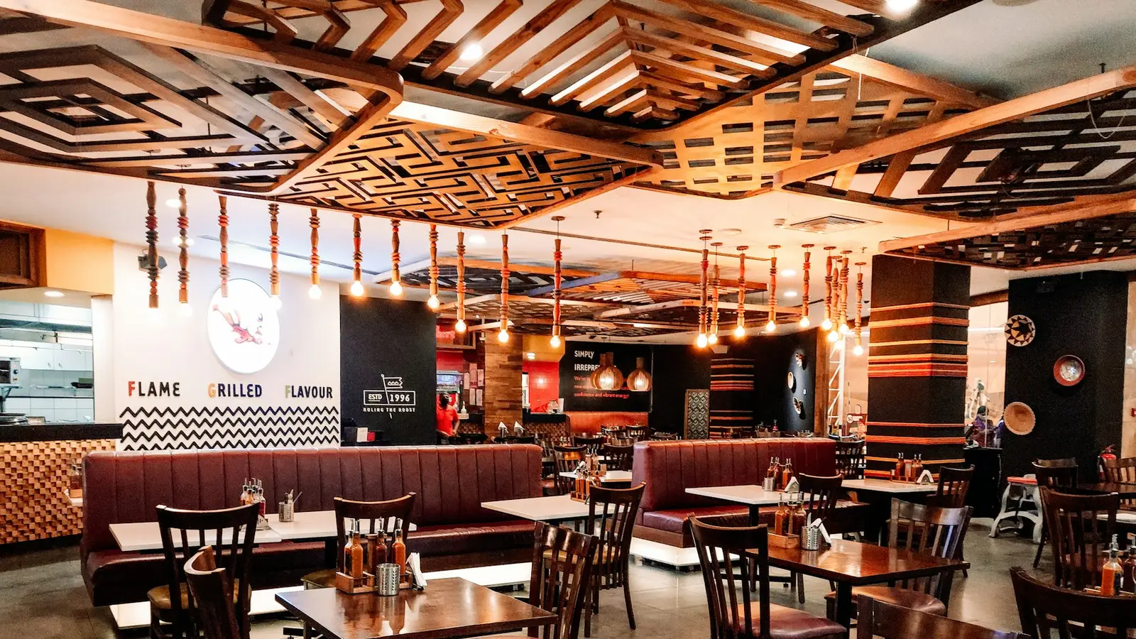 A restaurant dining room with wooden tables and warm lights